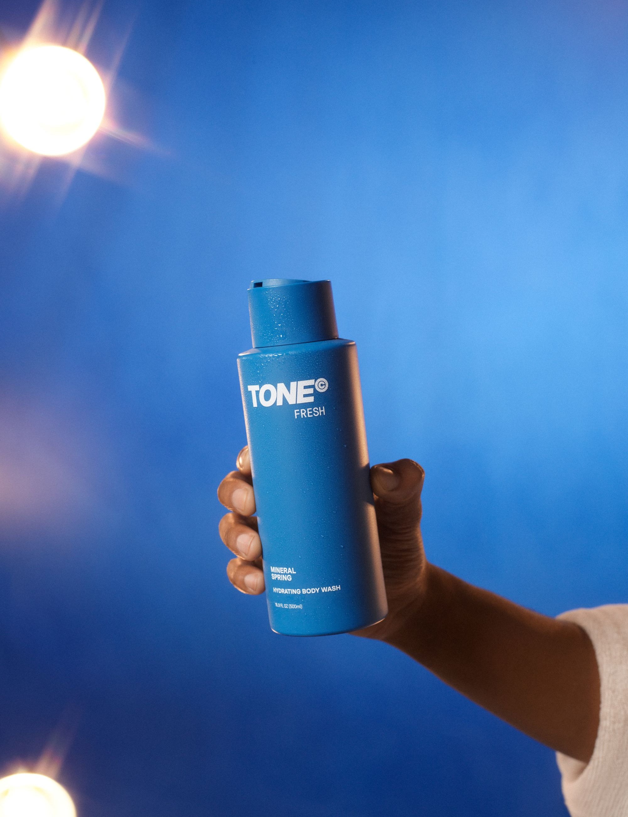 Hand Holding TONE Mineral Spring Hydrating Body Wash