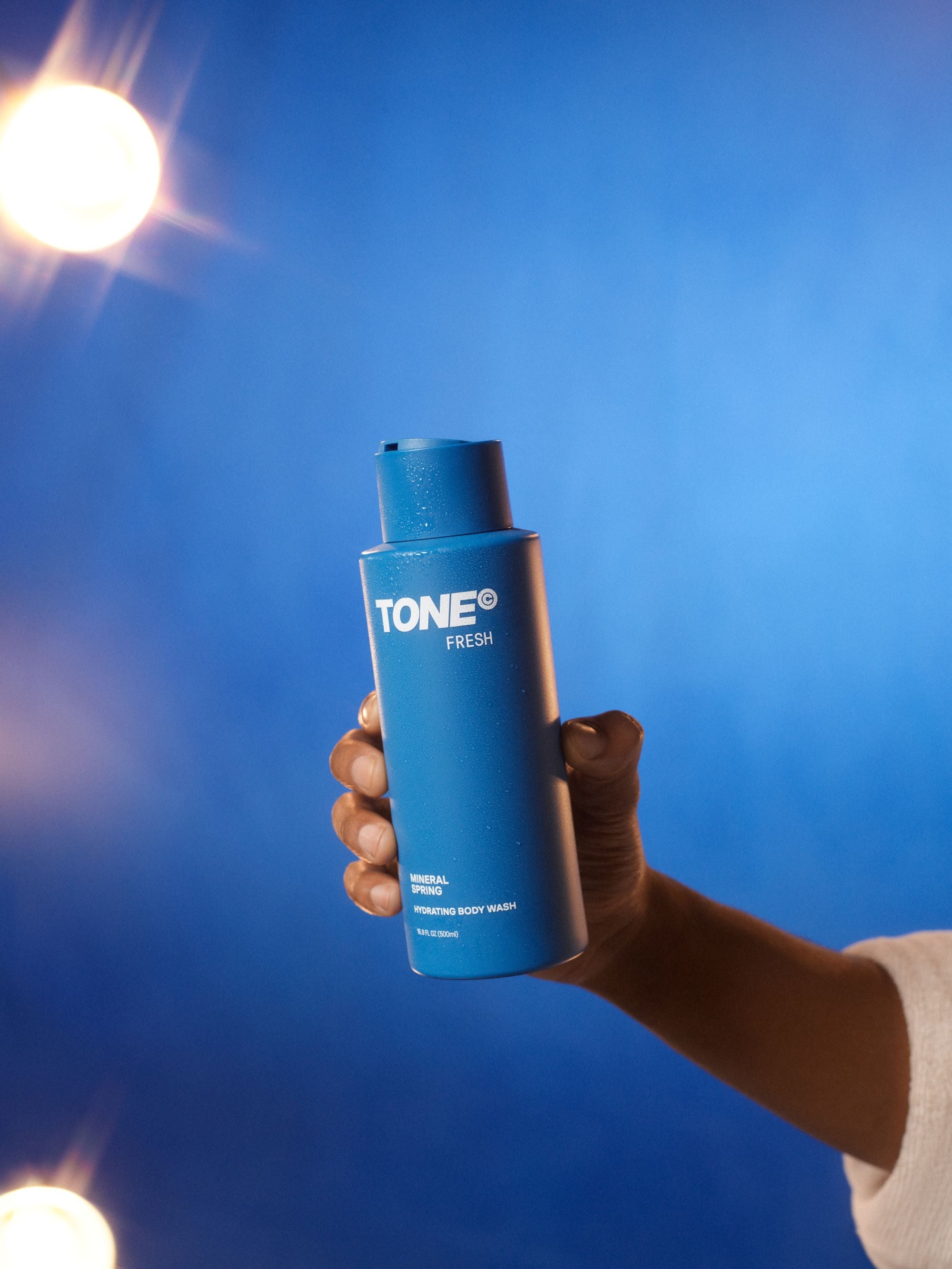 Hand Holding TONE Mineral Spring Hydrating Body Wash