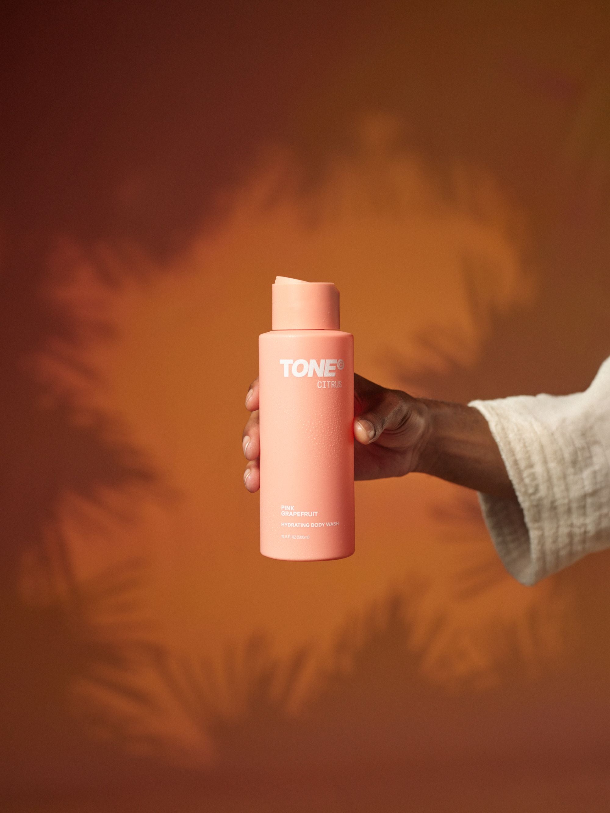 Hand Holding TONE Citrus Pink Grapefruit Hydrating Body Wash