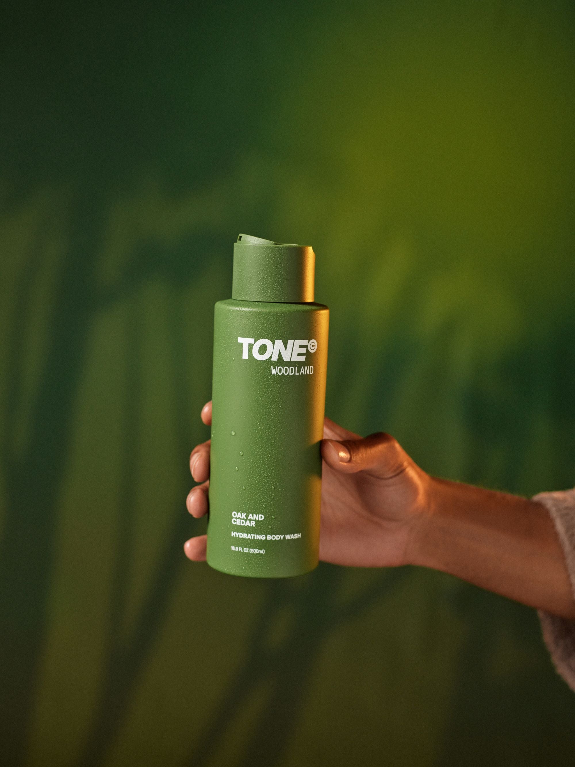 Hand Holding TONE Woodland Oak and Cedar Hydrating Body Wash