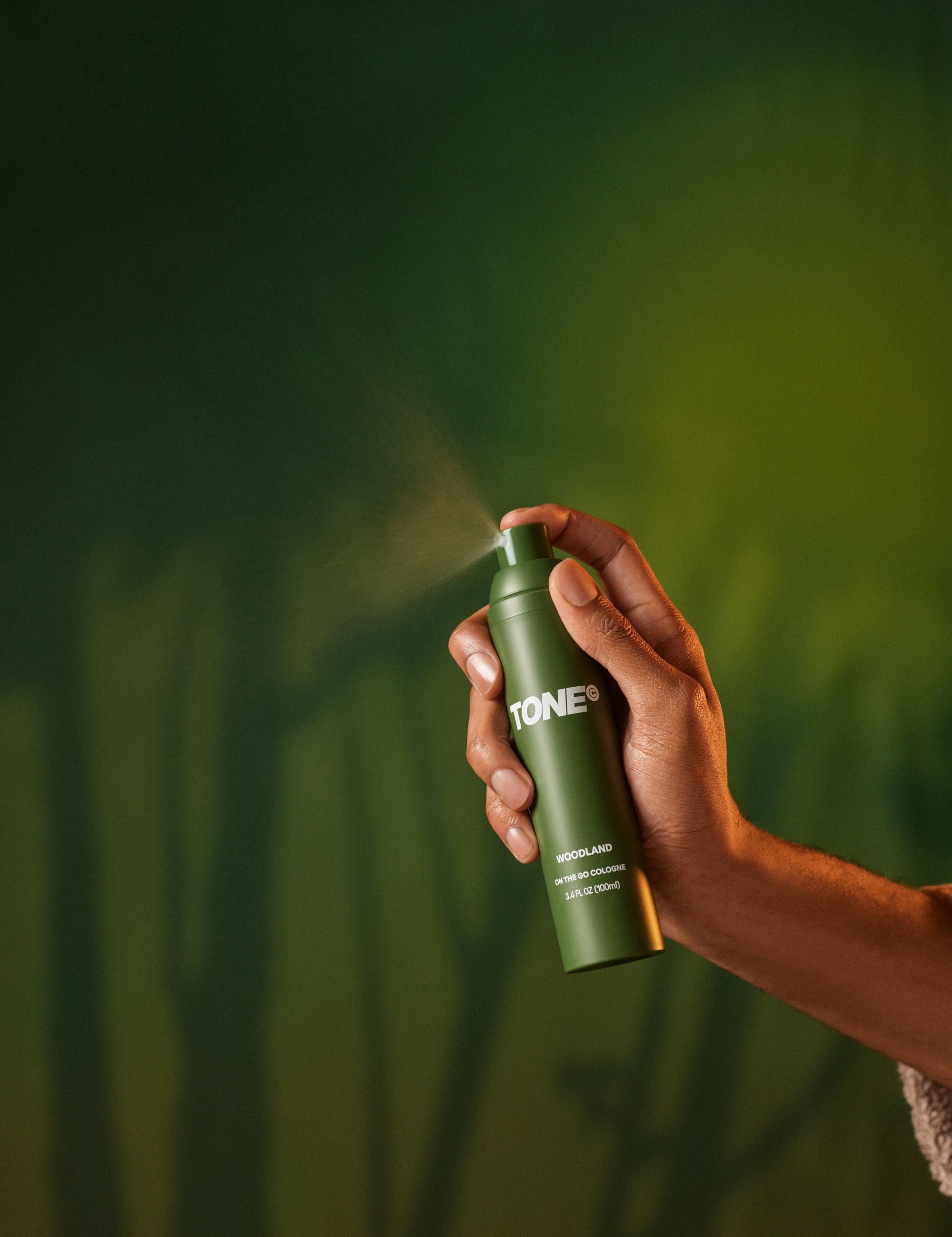 Hand Holding TONE Woodland On the Go Cologne