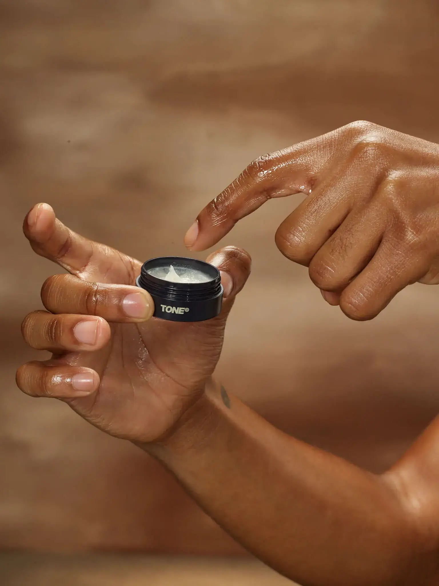 Hand Using TONE Coconut Lip Balm