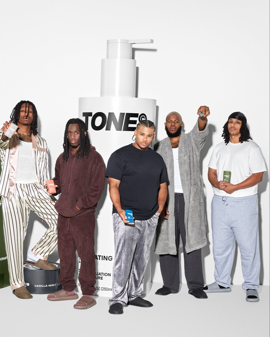 AMP members holding TONE products with larger TONE products in the background